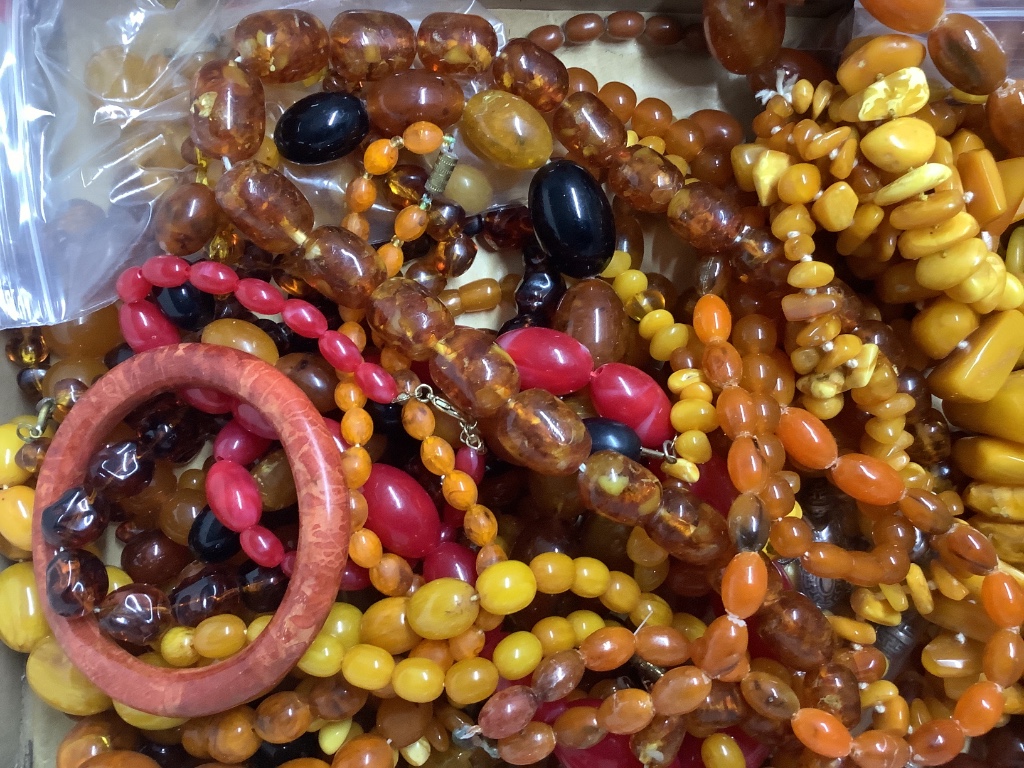 A quantity of assorted amber and faux amber necklaces.